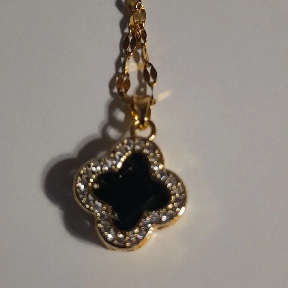 Floral Pendant on gold chain that adjusts to fit any size.